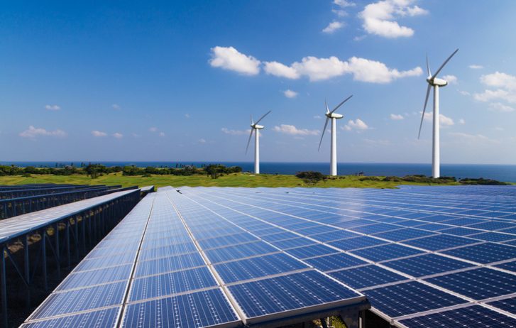 Solar panels and wind turbines by the coast — renewable energy recruitment